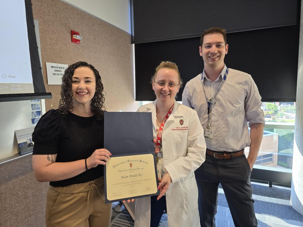 Picture of Alison and two residents with award