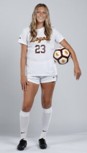 Photo of Ava Bryan in Loyola soccer uniform with ball